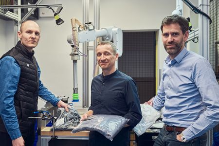 Nomagic Senior Management Team and founders, Marek, Kacper and Tristan, standing in front of robotic arm_Thumbnail 753x502.jpg