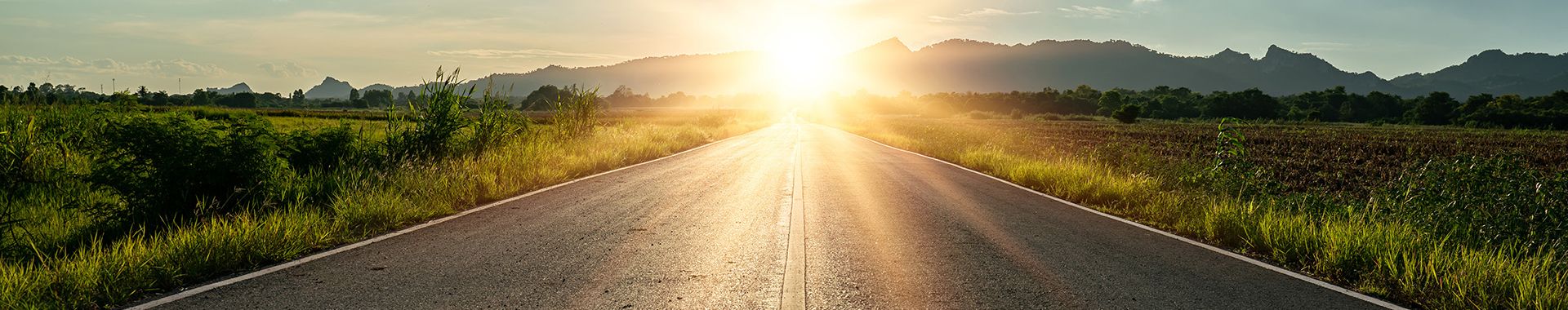 On the road in the middle of asphalt road at sunset._Page Banner.jpg