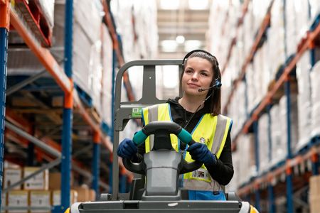 OneVASTwarehouse Success Story Thumbnail_female colleague driving warehouse vehicle_753x502.jpg